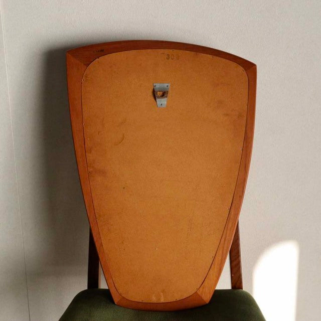 Mid-century vintage teak wall mirror from Denmark with smooth rounded triangular shape and wood grain edges.