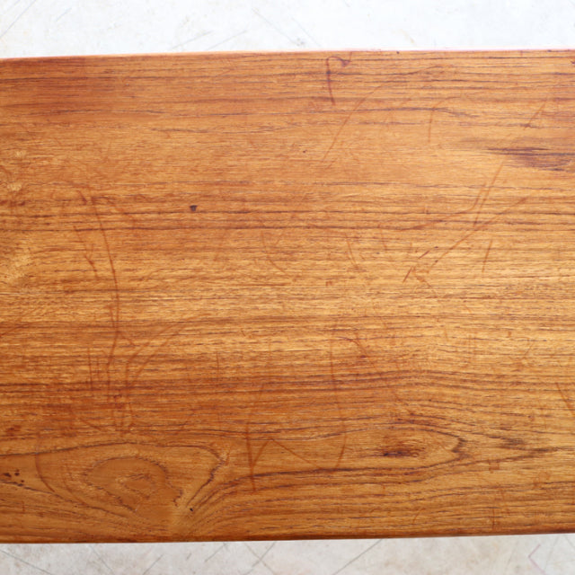 Vintage mid-century British teak coffee table top showing warm wood grain and natural patina.