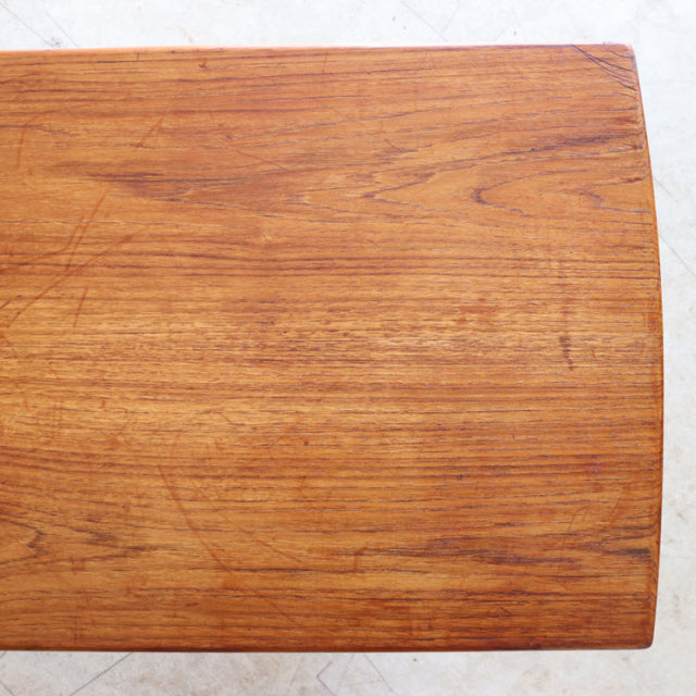 Vintage mid-century teak coffee table top with visible rich wood grain and rounded edges, British-Denmark style.