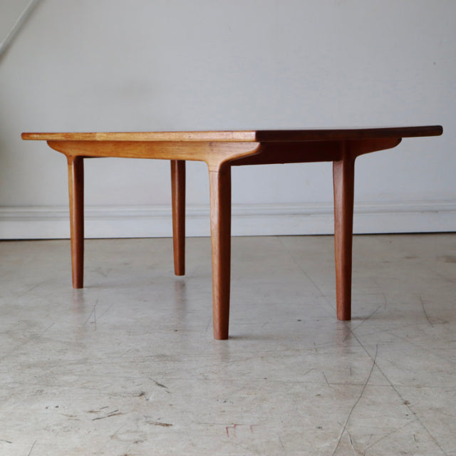 Mid-century vintage teak coffee table with clean lines, tapered legs, and smooth wood grain, British-Denmark style.