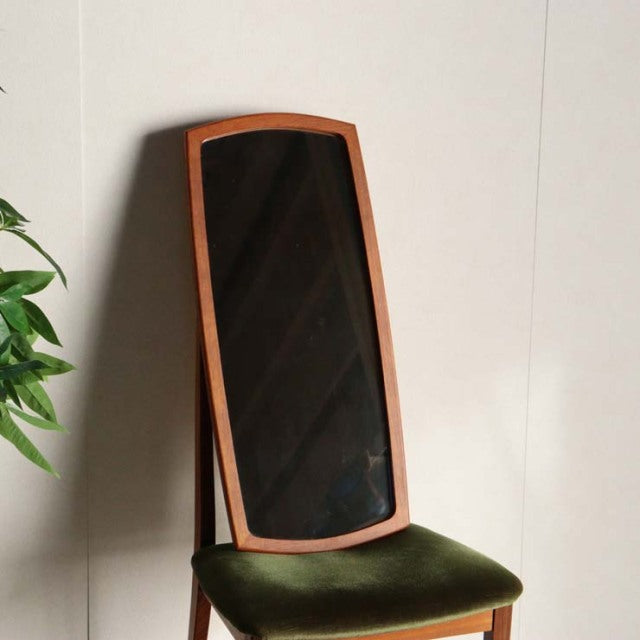 Vintage British mid-century teak mirror with rich wood grain and slender angled legs, green velvet cushioned seat.