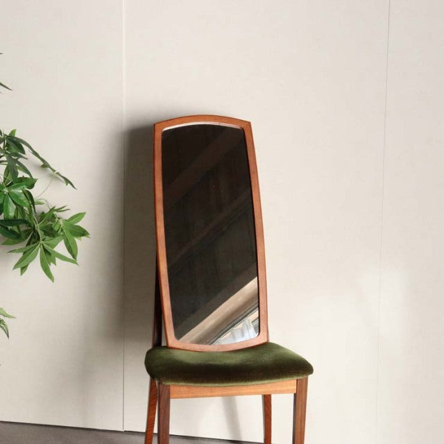 Mid-century British vintage teak framed mirror with curved top and green velvet cushioned seat stool.