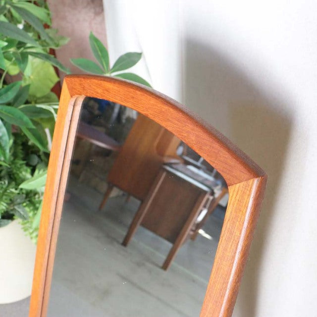 Mid-century British vintage teak mirror with arched top, smooth wood grain, and slim frame, Denmark style.