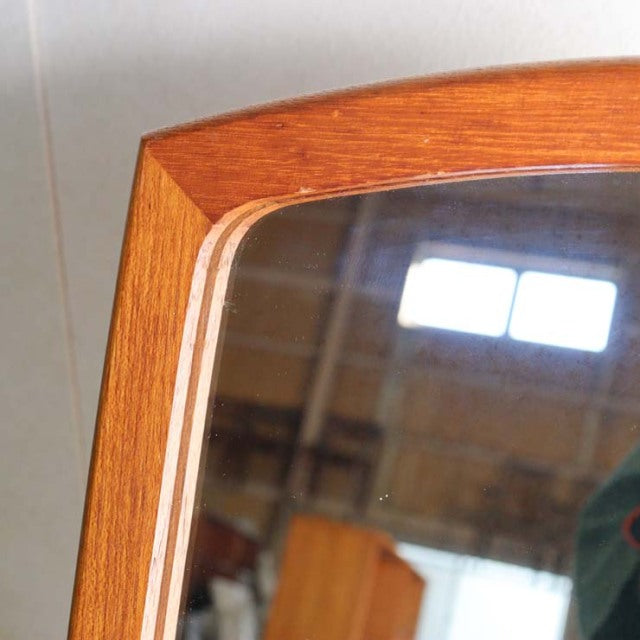 Mid-century British vintage teak mirror with rich wood grain and rounded rectangular frame.