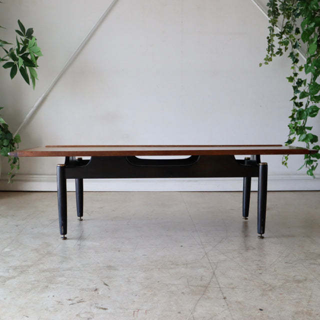 Vintage British G-Plan mid-century teak coffee table with sleek black legs and clean wood grain top.