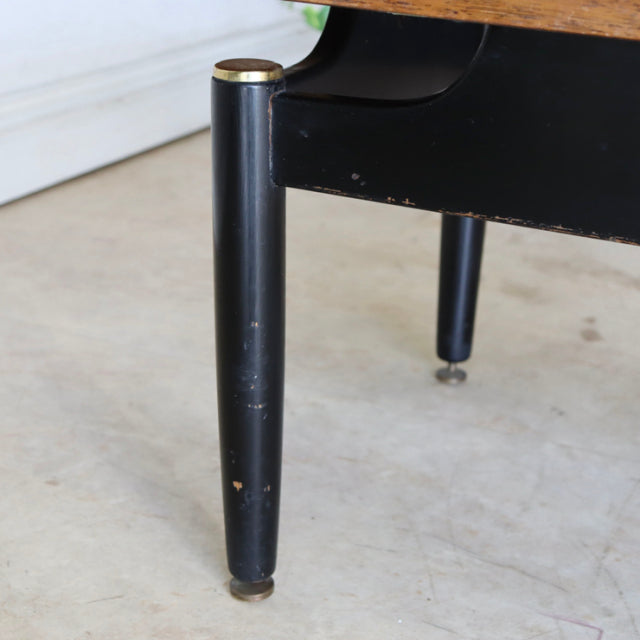 Black tapered leg of vintage Danish teak mid-century G-Plan coffee table with brass cap and slight wear.
