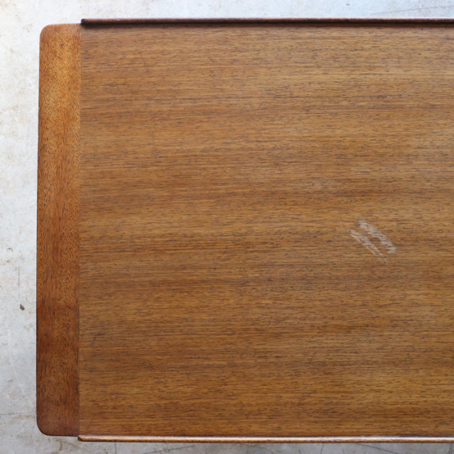 Vintage teak G-Plan mid-century British coffee table top showing warm wood grain and rounded corner detail with slight.