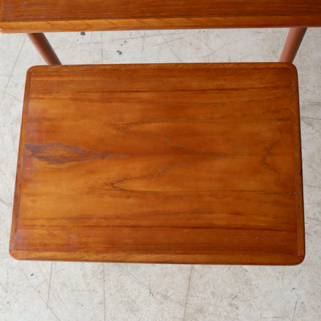 Mid-century vintage teak nest table from Denmark with smooth wood grain and rounded edges.