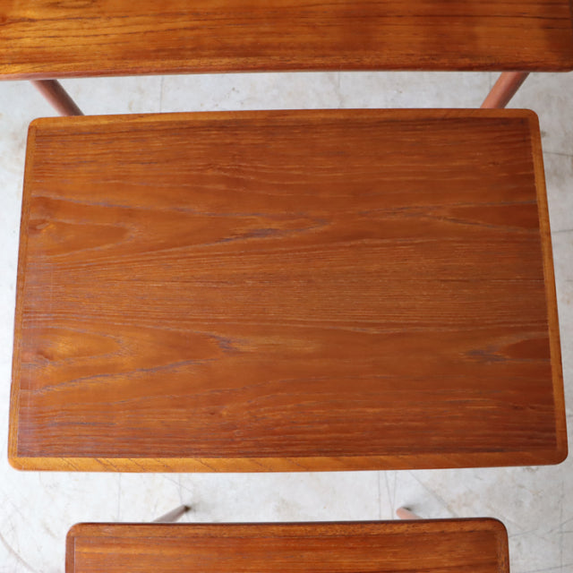Vintage mid-century teak nest coffee table from Denmark with smooth wood grain and slender tapered legs.