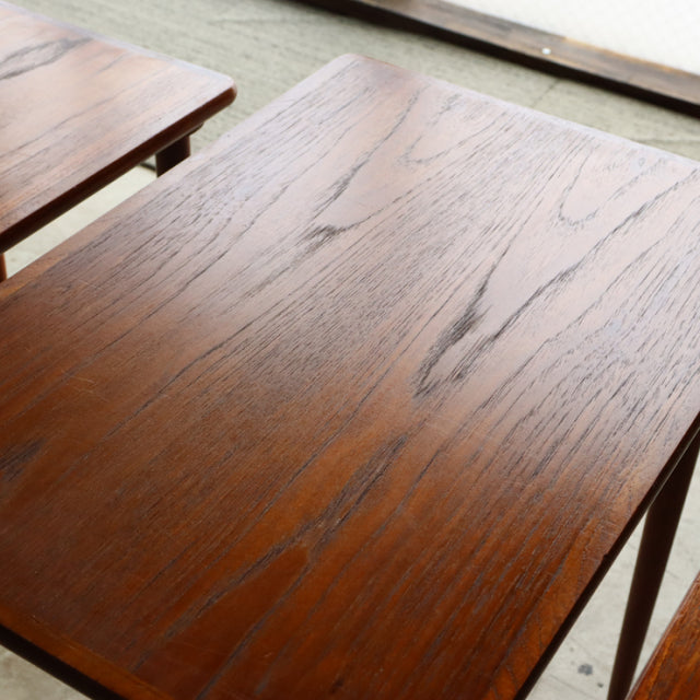 Vintage mid-century Danish teak nest tables with rich wood grain and slender tapered legs in excellent condition.