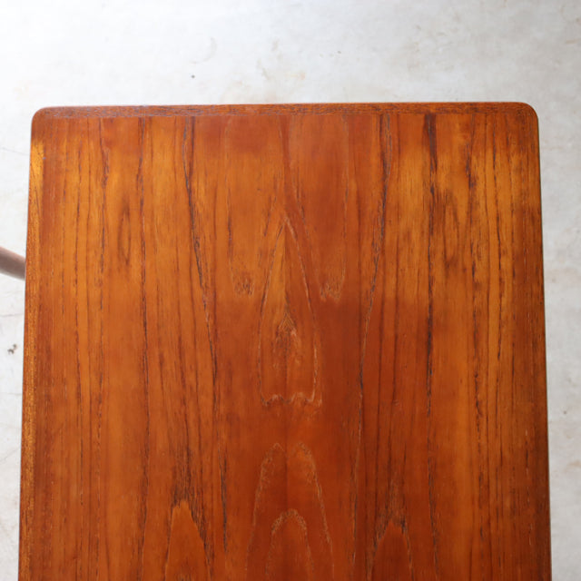 Vintage mid-century Danish teak nest table top with rich wood grain and smooth finish.