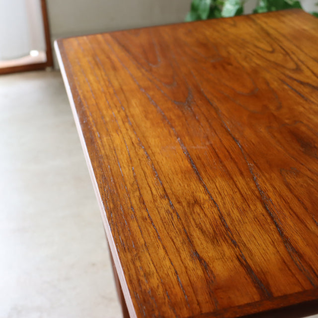 Vintage teak nest table from mid-century Denmark, showing rich wood grain and smooth edges.