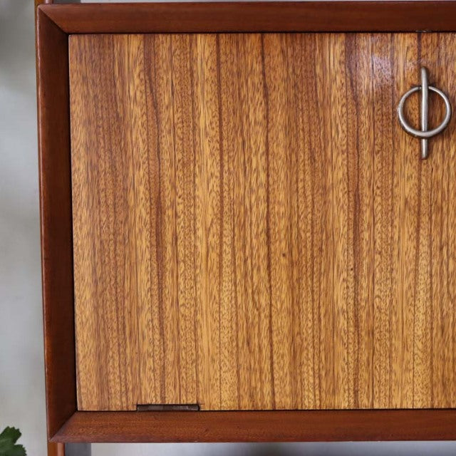 Vintage teak mid-century British room divider cabinet with rich wood grain and iron leg detail.