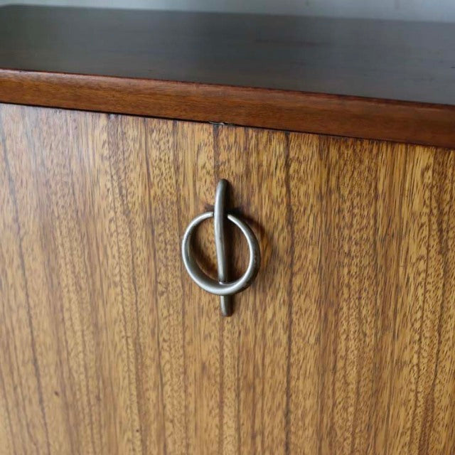 Vintage mid-century teak room divider with rich wood grain and distinctive British iron leg handle.