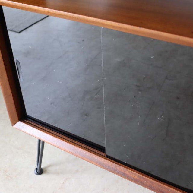 Mid-century vintage teak room divider with rich wood grain and slender British iron legs from Denmark.