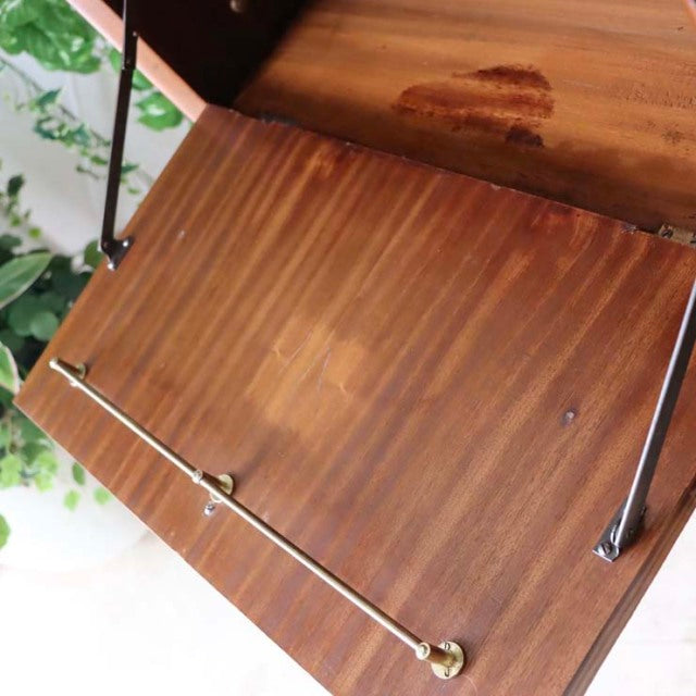 Mid-century vintage teak room divider with British design, iron legs, visible wood grain, and brass detail.