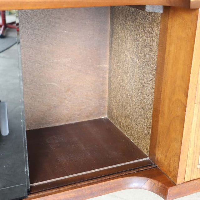 Vintage teak mid-century British room divider cabinet corner with iron legs and visible wood grain details.