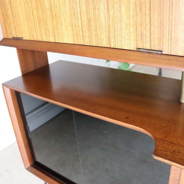 Vintage teak mid-century British room divider with iron legs and smooth wood grain finish.
