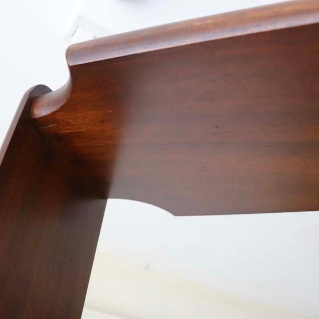 Vintage teak room divider with smooth grain, mid-century British design, featuring curved iron legs and warm wood tones from .