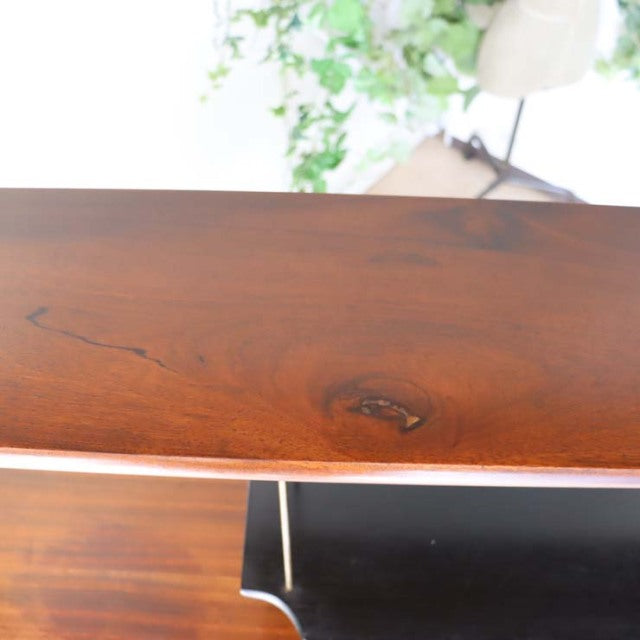 Vintage teak mid-century room divider with smooth polished grain and iron legs, British-Danish style.