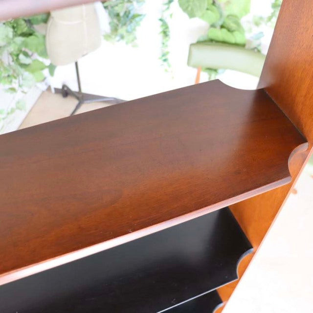 Mid-century British vintage teak room divider with smooth wood grain and iron legs.