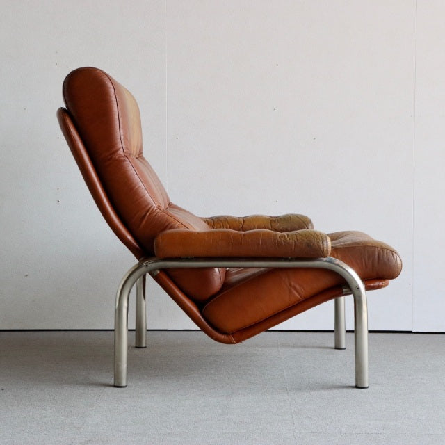 Mid-century British vintage sofa with rich brown leather upholstery and sleek teak wood grain legs, sleek low-profile Danish .