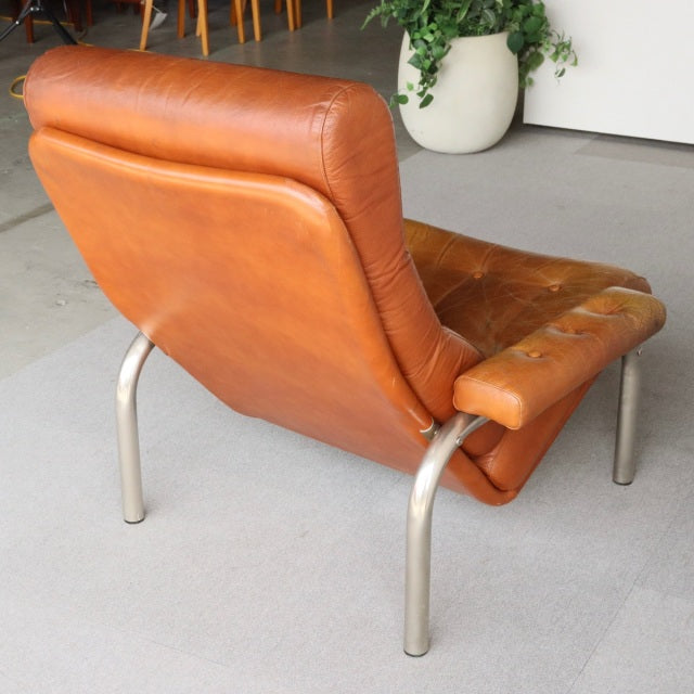 Vintage mid-century British leather sofa with teak frame, curved metal legs, and rich patina.