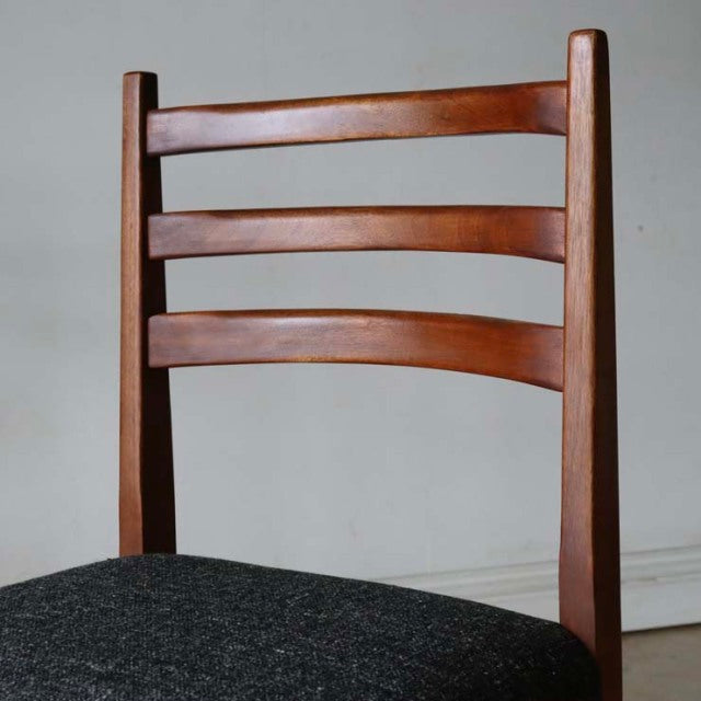 Mid-century vintage teak dining chair with ladder back and dark upholstered seat, British-Denmark style.