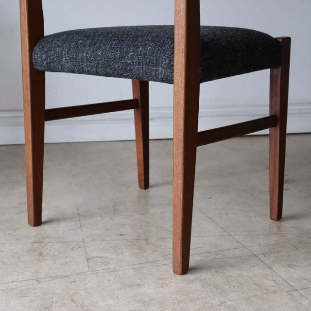 Mid-century British vintage teak dining chair with dark upholstered seat and tapered legs, showing rich wood grain and clean .