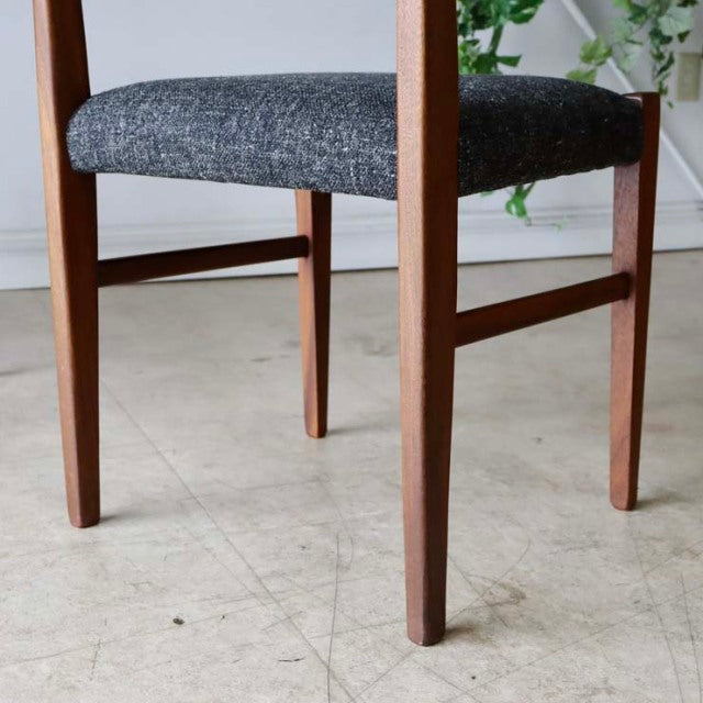Mid-century vintage teak dining chair with British design featuring tapered legs and dark gray upholstered seat.
