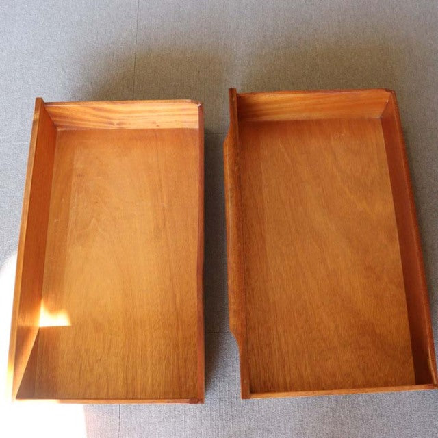 Two vintage teak drawers with smooth wood grain and mid-century British design, rectangular form with raised edges.