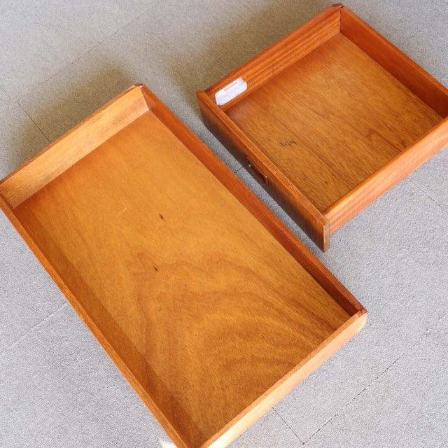 Vintage teak wood drawers with smooth grain and clean mid-century British design details.