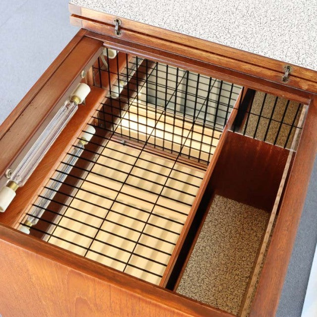 Mid-century vintage teak sideboard interior with metal grid, glass top, and partitioned compartments.