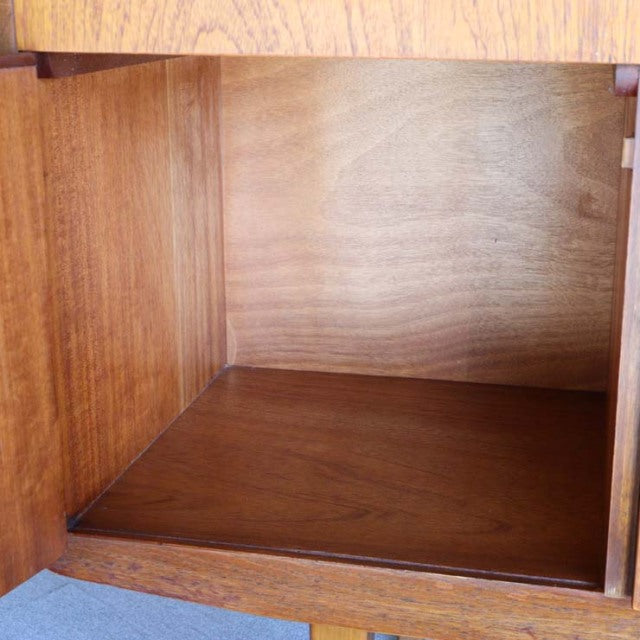 Interior view of vintage teak sideboard showcasing smooth wood grain and warm mid-century finish.