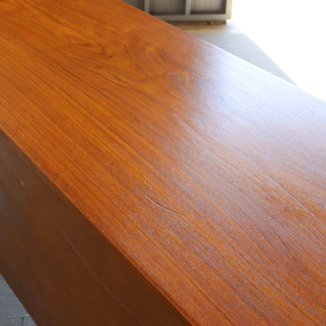 Mid-century vintage British teak sideboard top surface with rich wood grain and warm honey tones.