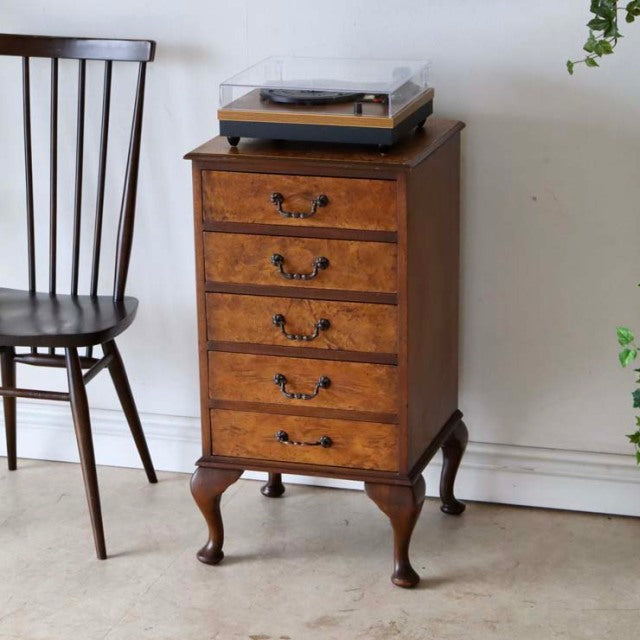 Vintage British mid-century teak cabinet with five drawers, ornate handles, and curved cabriole legs.