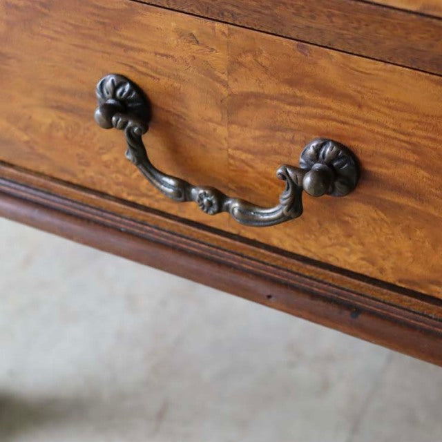 Close-up of vintage British teak record cabinet drawer with detailed dark metal curved handle and rich wood grain.