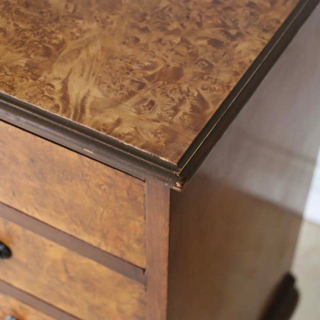 Close-up of vintage British mid-century walnut record cabinet corner showing rich wood grain, beveled edges, and dark trim.