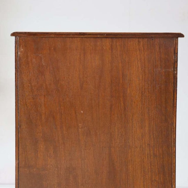 Vintage British mid-century teak record cabinet with rich wood grain and clean lines, solid rectangular form.