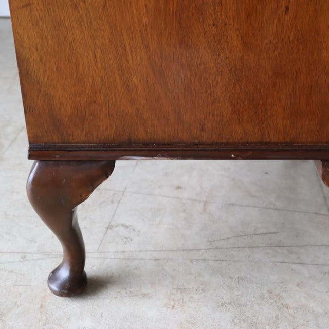Mid-century British vintage teak cabinet leg with curved clawfoot design and rich wood grain texture.