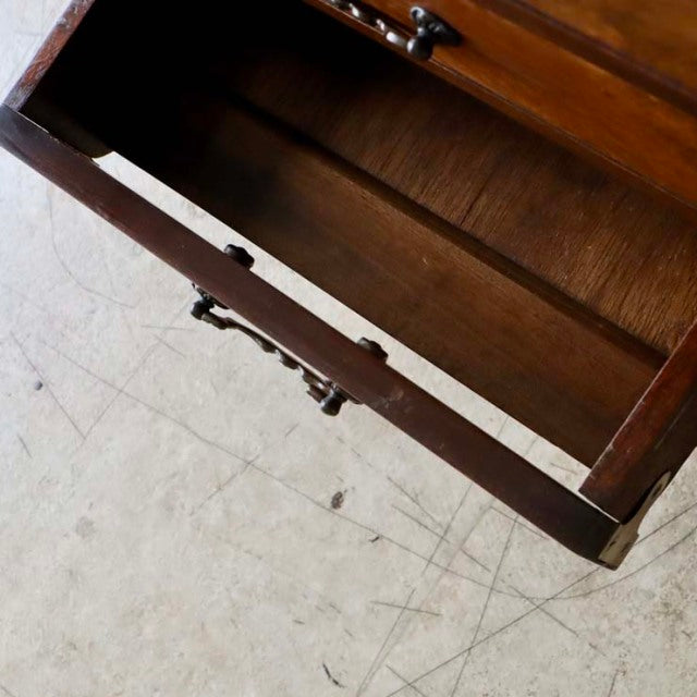 Open drawer of vintage British mid-century walnut record cabinet showing rich wood grain and brass handles.