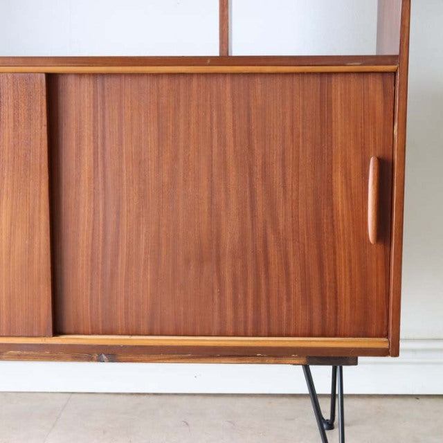 Mid-century vintage teak room divider with rich wood grain and British-design iron hairpin legs.