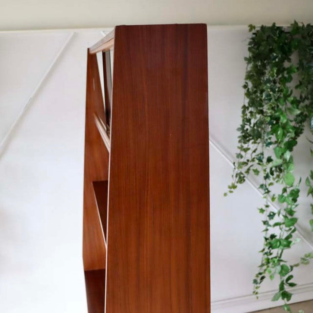 Mid-century British vintage room divider in teak wood with smooth grain and iron legs, Danish design influence.