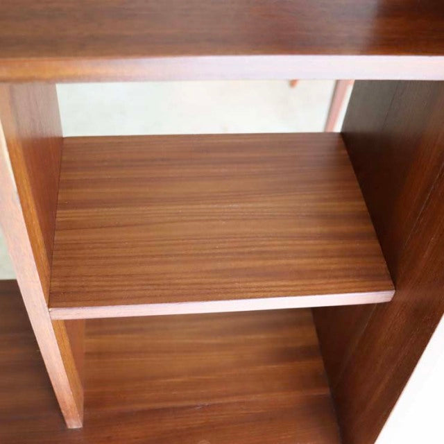 Vintage teak room divider shelf with visible wood grain and smooth mid-century British design details.