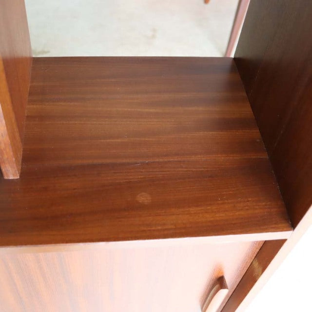Vintage teak mid-century British room divider with iron legs, showcasing rich wood grain and smooth finish.