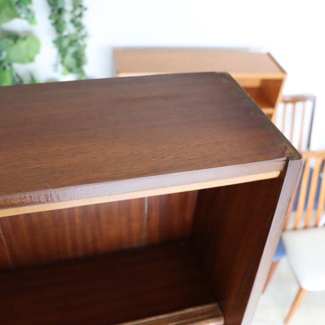 Vintage teak mid-century British room divider with iron legs, rich wood grain, and smooth finish.