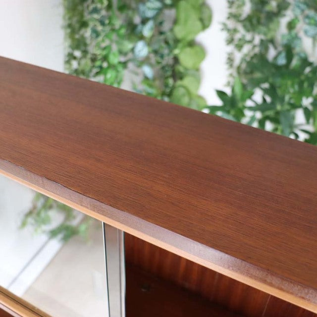 Mid-century vintage teak room divider with polished iron legs and rich wood grain, British-Danish design.