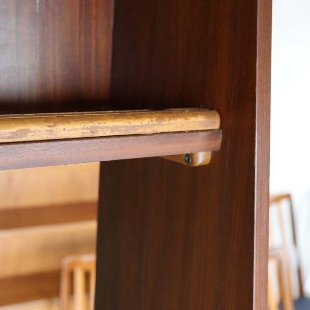 Close-up of vintage teak wood room divider corner with rich grain and smooth British mid-century craftsmanship.