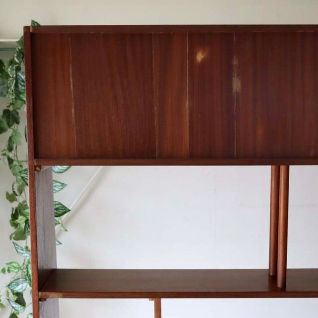 Mid-century vintage teak room divider with British design, featuring iron legs and rich wood grain from Denmark.