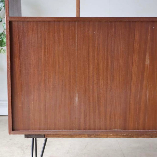Mid-century Danish vintage teak room divider with rich wood grain and black iron legs in British style.